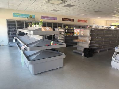 many empty shelves in a store that are full of items