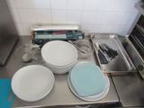 many plates and pans sitting on the counter in the kitchen