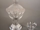 a clear glass vase and a clear glass cup on a table