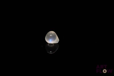 a close up of a white light shining on a black surface
