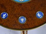 a wooden table with a blue and white clock on it