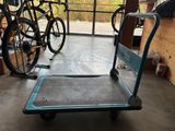 a blue cart with a bike on it in a garage