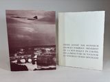 an old photo of a book with a picture of a plane flying in the sky