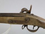 a close up of a rifle with a wooden handle on a white background