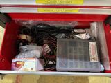 a red tool box filled with assorted electronics