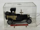 a small toy car in a clear box on a table
