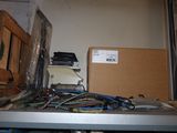 a picture of a bunch of wires on a shelf in a room