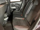 the back seats of a car with a toilet in the back