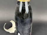 a close up of a bottle of champagne next to a bottle opener