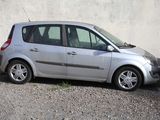 a small silver car parked on the side of the road