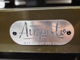 a close up of a metal plate with a name on it