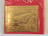 a red bag with a gold stamp on it and a pair of scissors