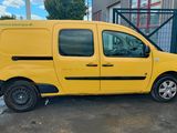 the yellow van is parked in front of a building