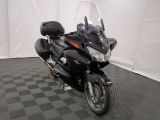 une moto noire garée sur un sol à damier