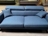 the blue couch is sitting in the middle of the room