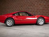 a red sports car parked in front of a brick wall