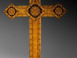 a close up of a wooden cross on a white surface