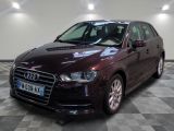 an image of a maroon audi car in a showroom