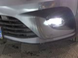 a close up of the front of a car with a light on