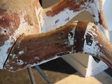 a wooden horse that is sitting on a metal stand