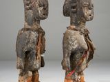 pair of carved wooden figures of a man and a woman