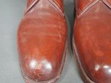 pair of brown leather boots with zippers on the side of them