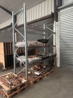 a large warehouse with a lot of wood on the floor