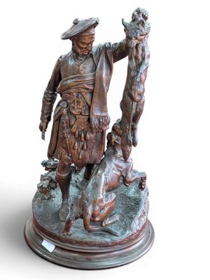 bronze statue of a man with a dog and a duck