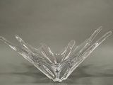 clear glass bowl sitting on top of a table with a gray background