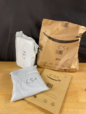 three bags of food sitting on a table next to a bag of food