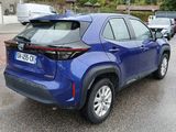 the rear end of a blue toyota rav parked in a parking lot