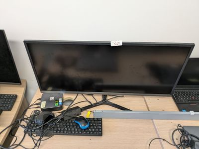 two laptops and a monitor on a desk