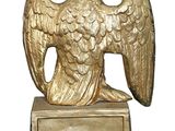 brass eagle with crown on pedestal on white background with copy space