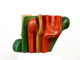a colorful sculpture of a hand made out of wood