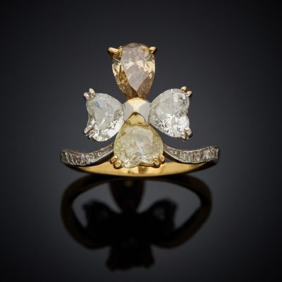 an image of a diamond and gold ring on a black surface