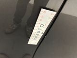 a person standing in front of a mirror with a ruler on it