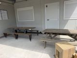 two picnic tables and two benches in a room