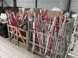 a lot of red and white baseball bats in a cage