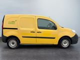 the yellow van is parked in a parking lot on a cloudy day