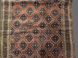 a brown and black rug sitting on top of a wooden floor