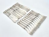 a lot of silverware on a table with a white background