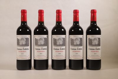 quatre bouteilles de vin sont alignées sur une table
