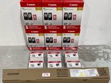 several canon ink cartridges are stacked on top of a cardboard box