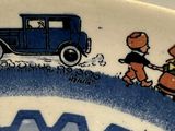 a blue and white plate with a picture of a car on it