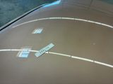 a sticker on the hood of a car in a garage