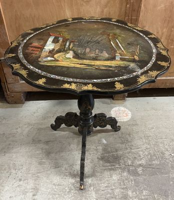 an old table with a painting on the top of it