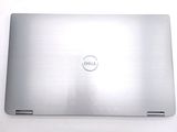 dell laptop computer sitting on top of a white table next to a keyboard