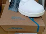 a box with a pair of white shoes on top of it