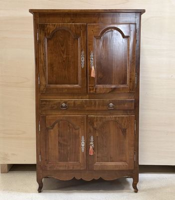 an image of a wooden cabinet with a door on top of it