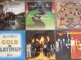 many different album covers on the wall of a store